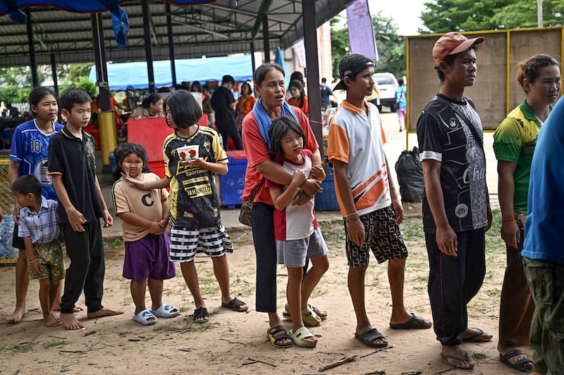 Evacuees displaced by the ongoing conflict between Thailand and Cambodia line up for food at a makeshift evacuation center inside a Buddhist temple in the Thai border province of Sisaket, Thailand, July 26, 2025.